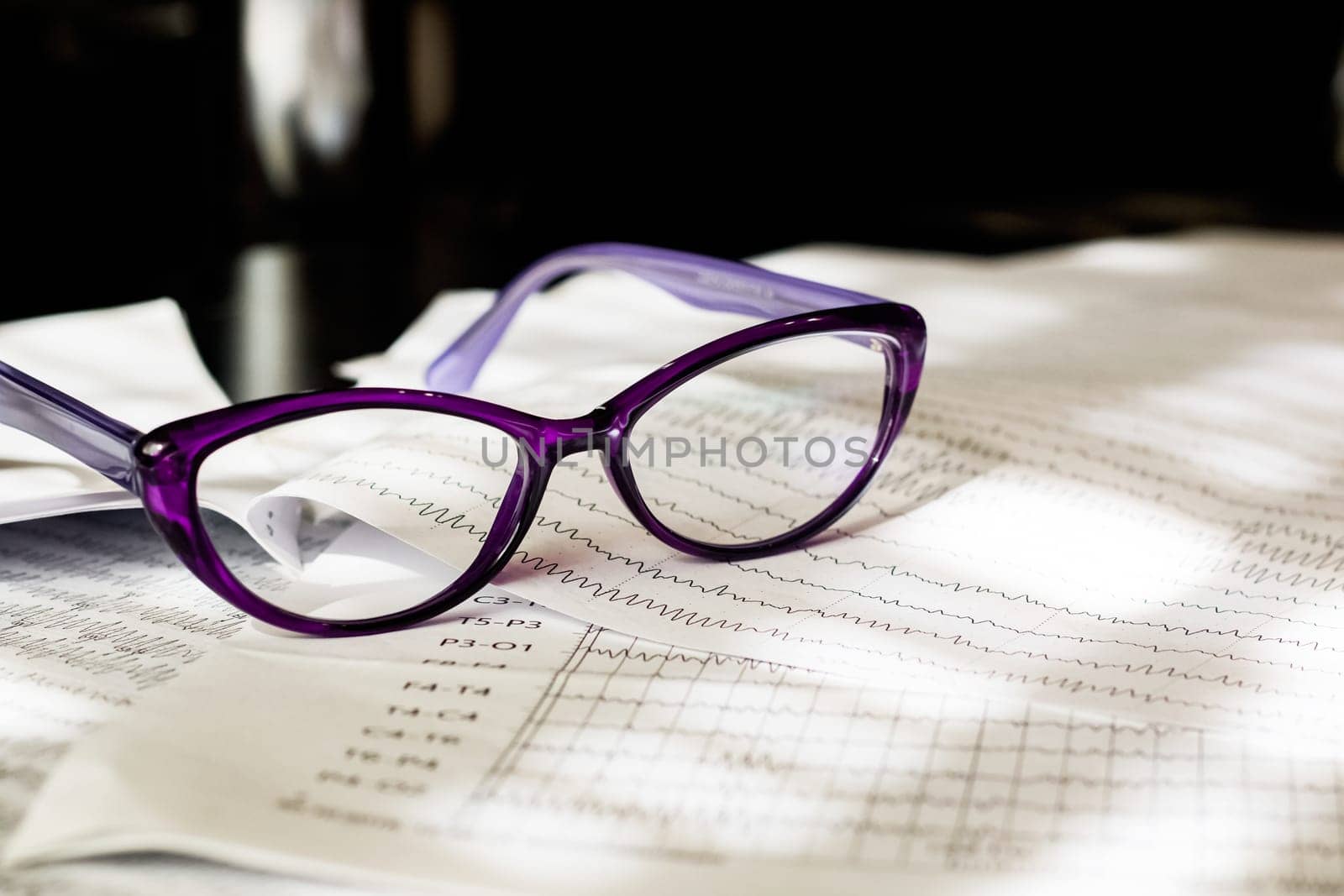 Electroencephalogram result on paper and glasses closeup, brain activity test