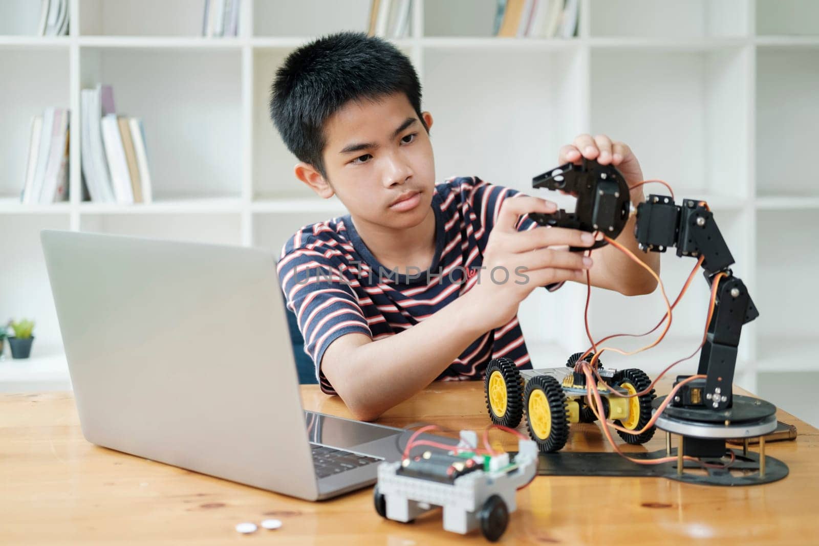 Student doing robot project in science technology of robotics programing and STEM education concept. by ijeab