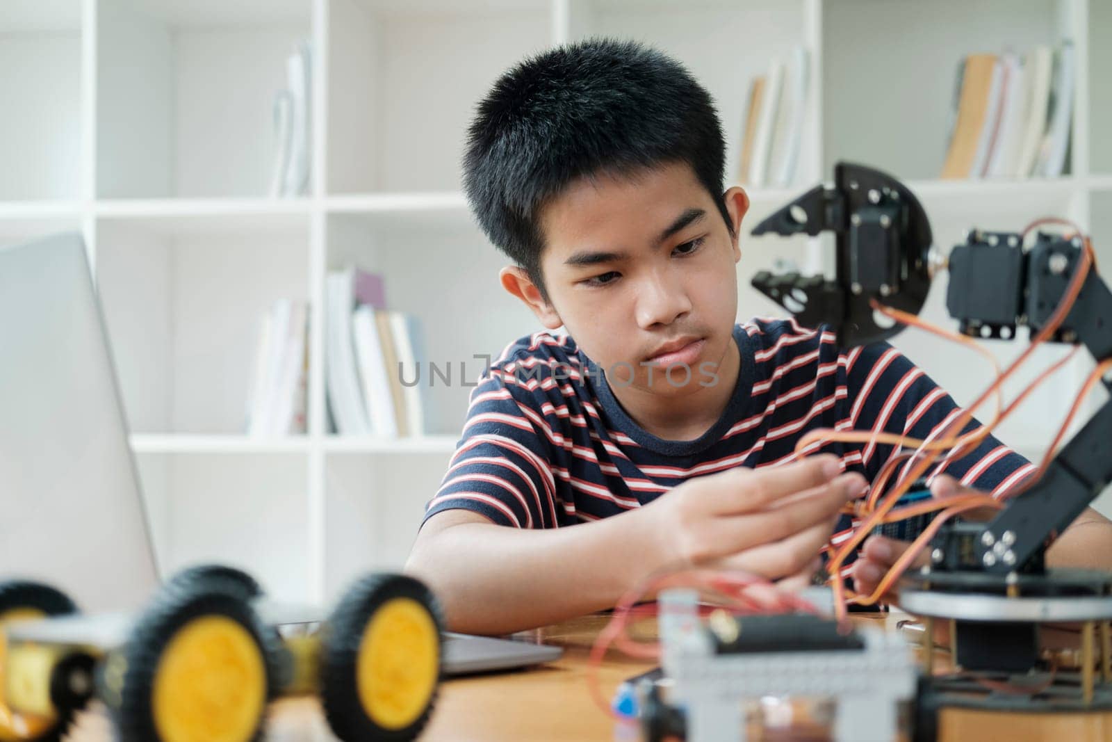 Student learning STEM education robotics for creating project studying for innovation robot models. New study generation for DIY electronic kits in mathematics engineering science technology computer code in computer technology classroom.