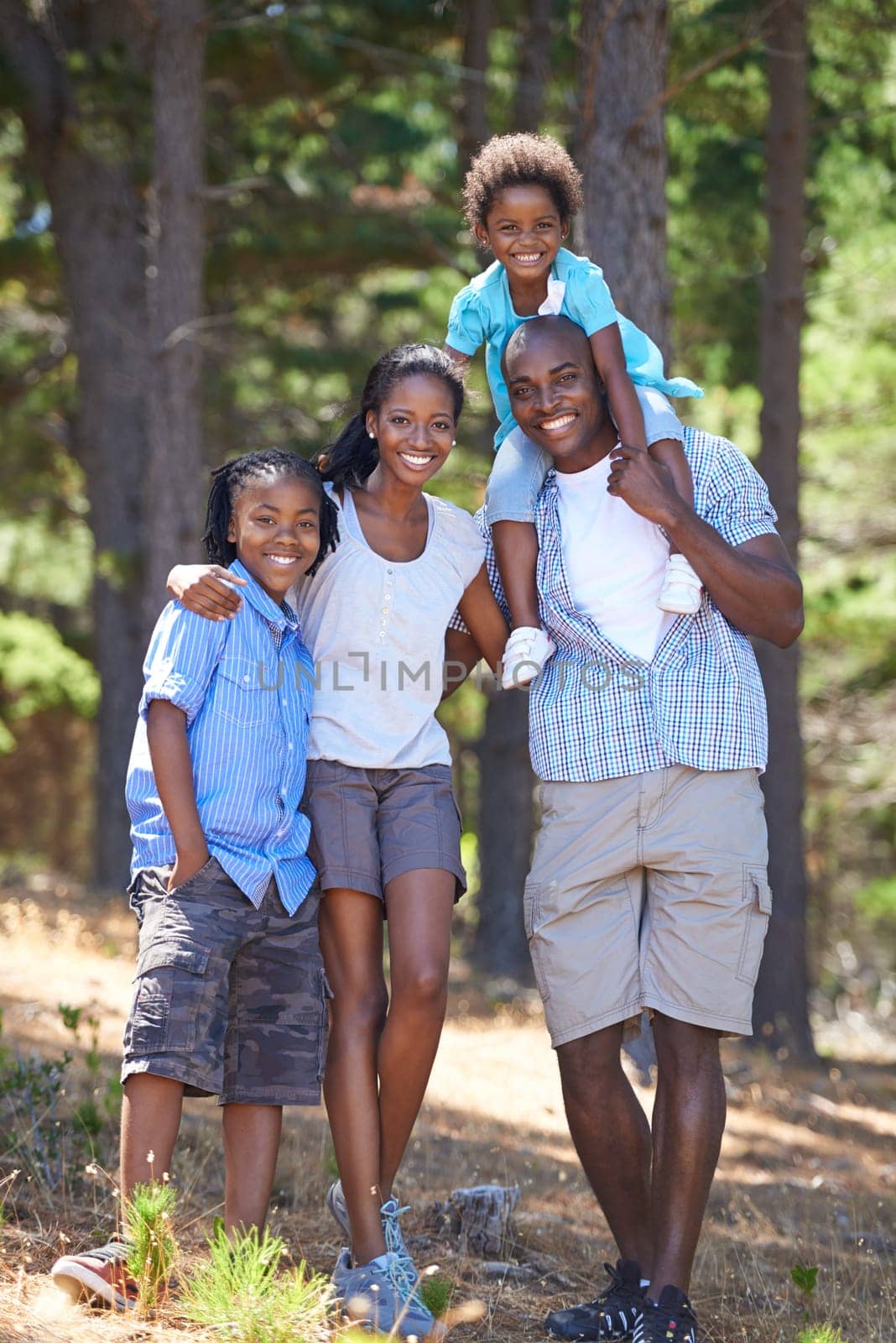 Happy, portrait and black family in forest bonding, fun or walking in nature together. Love, support and children with parents in a park for hiking adventure, journey or travel, explore or vacation.