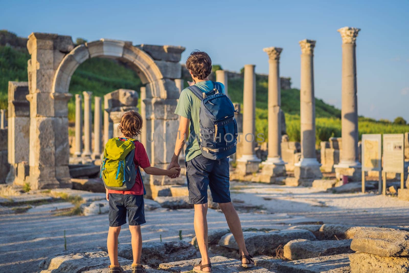 dad and son tourists at the ruins of ancient city of Perge near Antalya Turkey. Traveling with kids concept by galitskaya