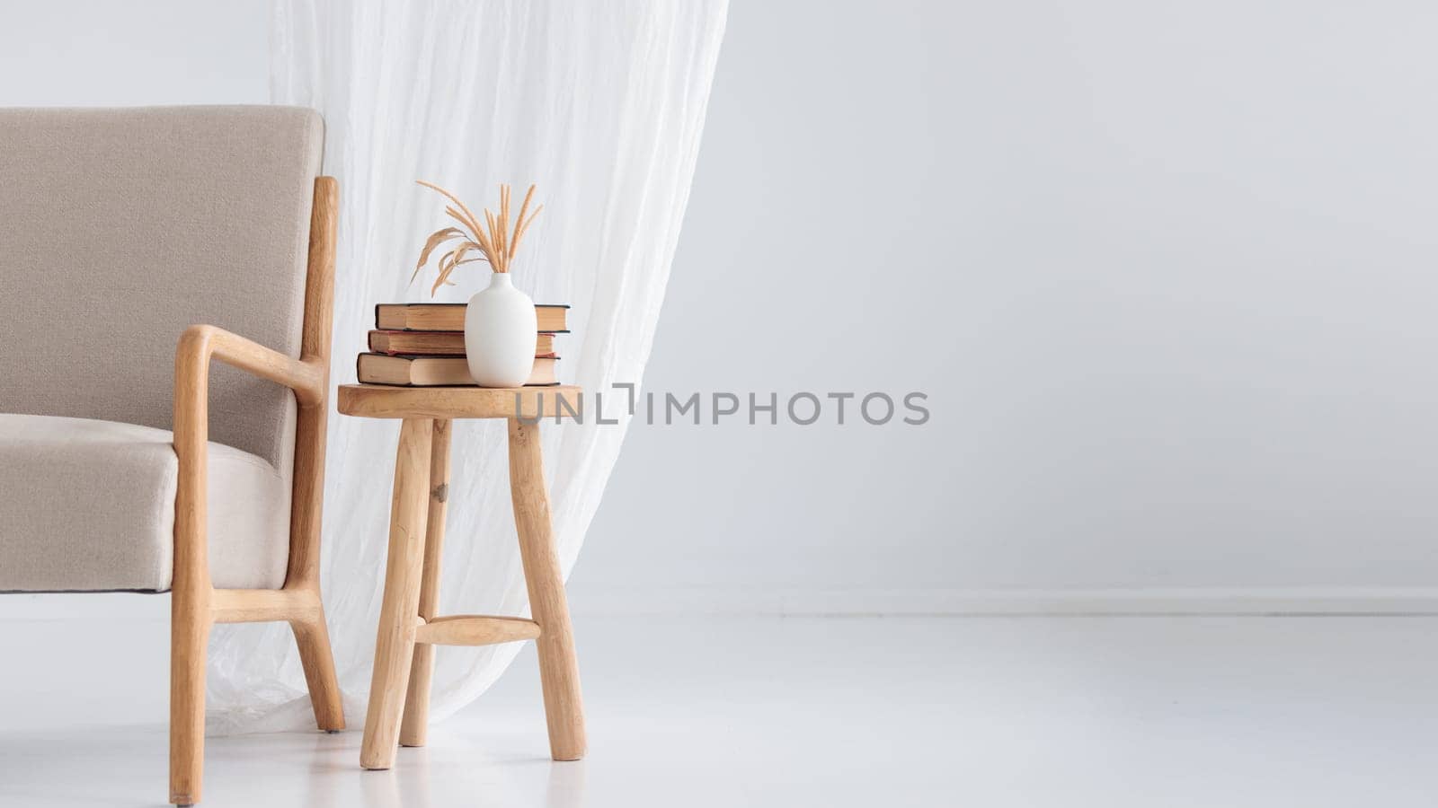Wooden handcraft chair with books and vase on a white background
