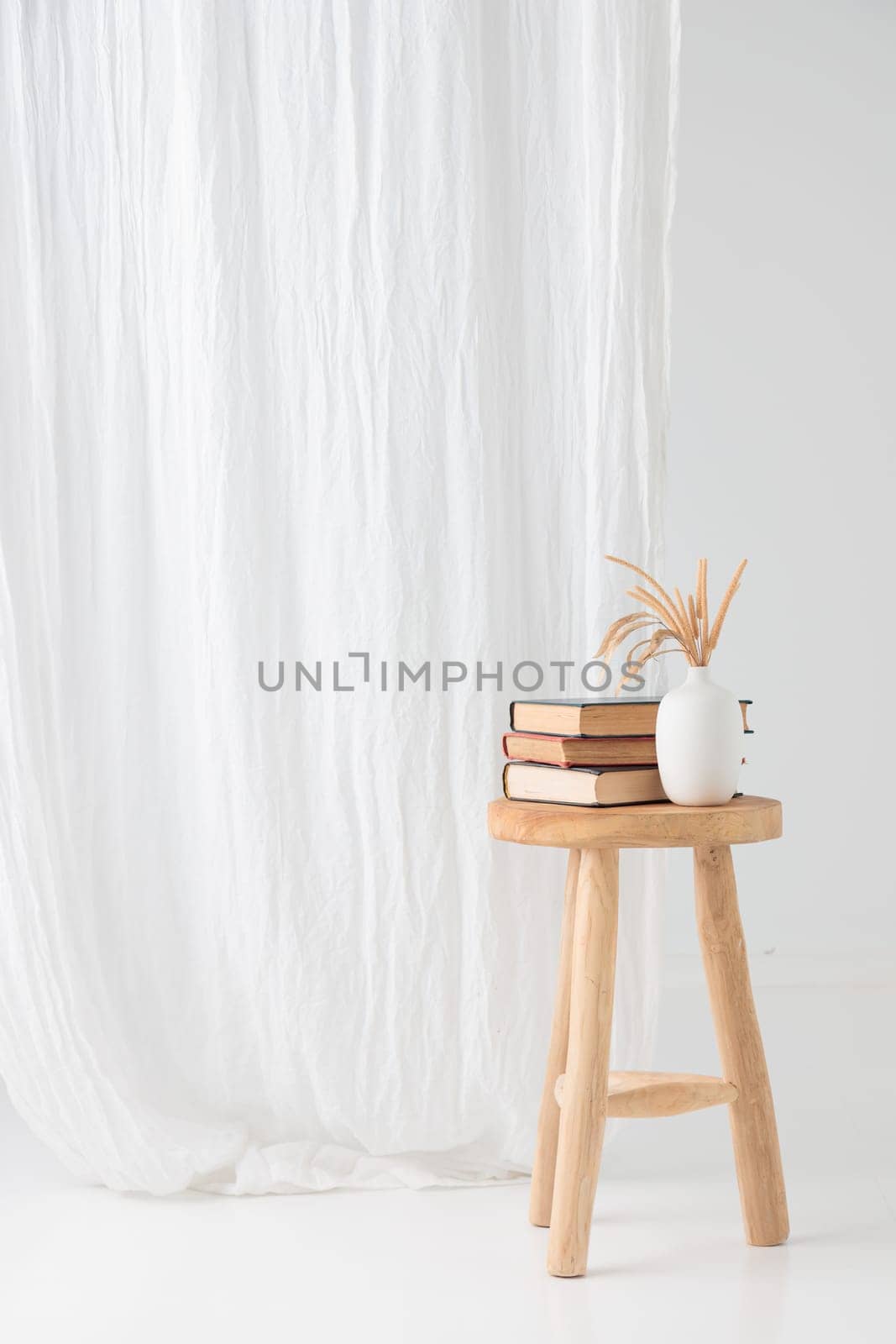 Wooden handcraft chair with books and vase on a white background