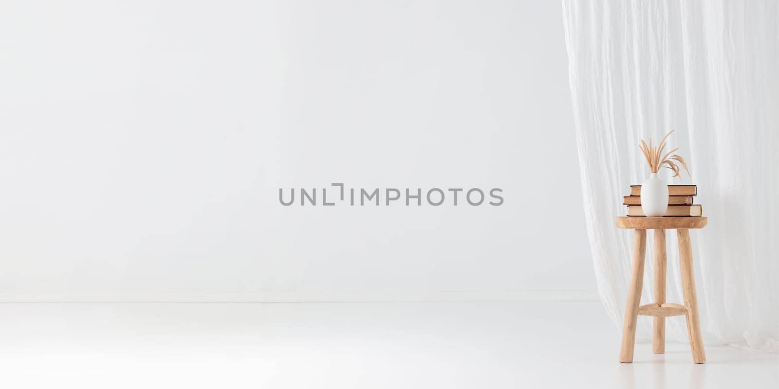 Wooden handcraft chair with books and vase on a white background