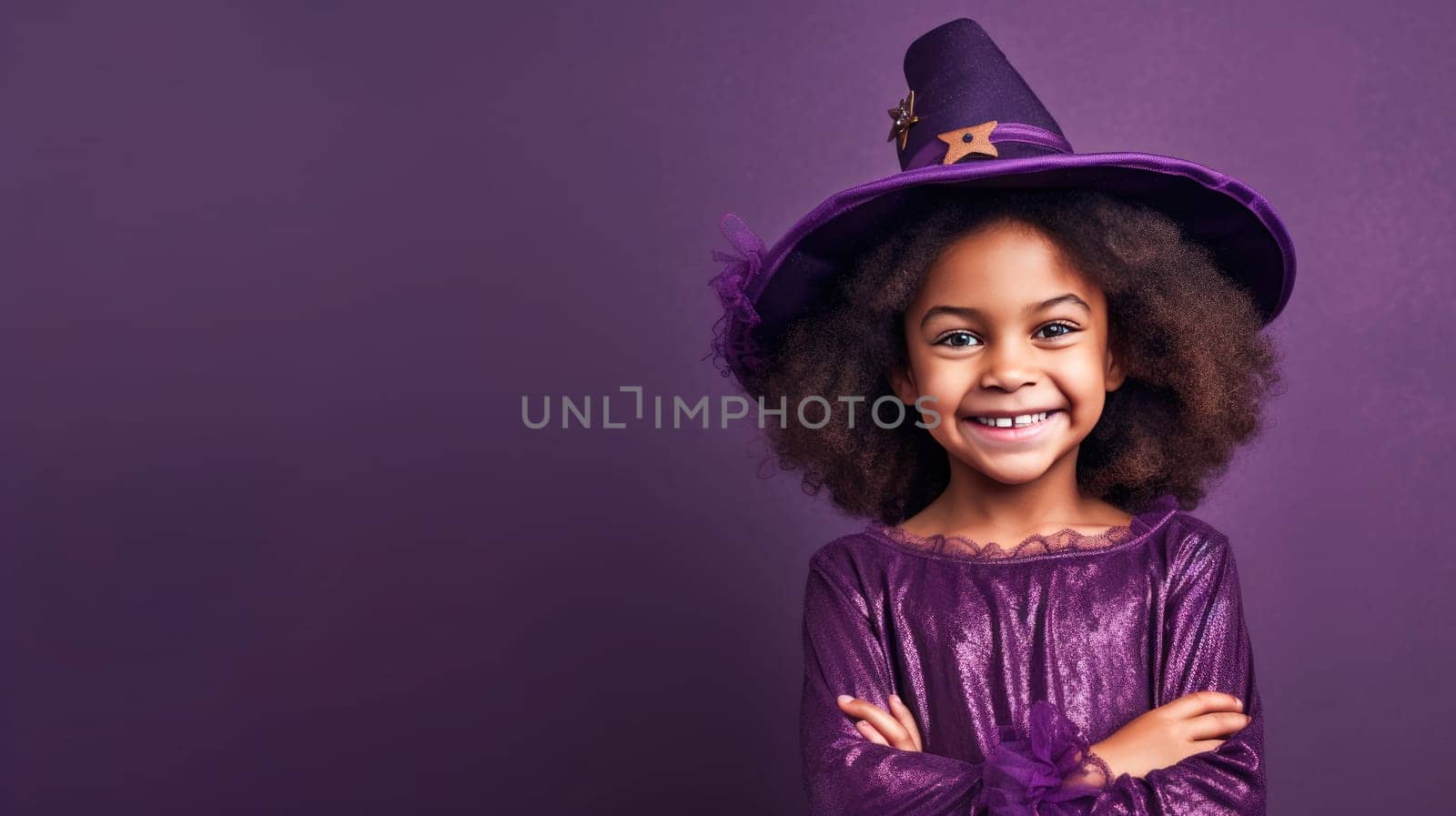 Cute african american girl in purple witch halloween costume looking at camera and smiling over purple background. Happy Halloween. Trick or treat