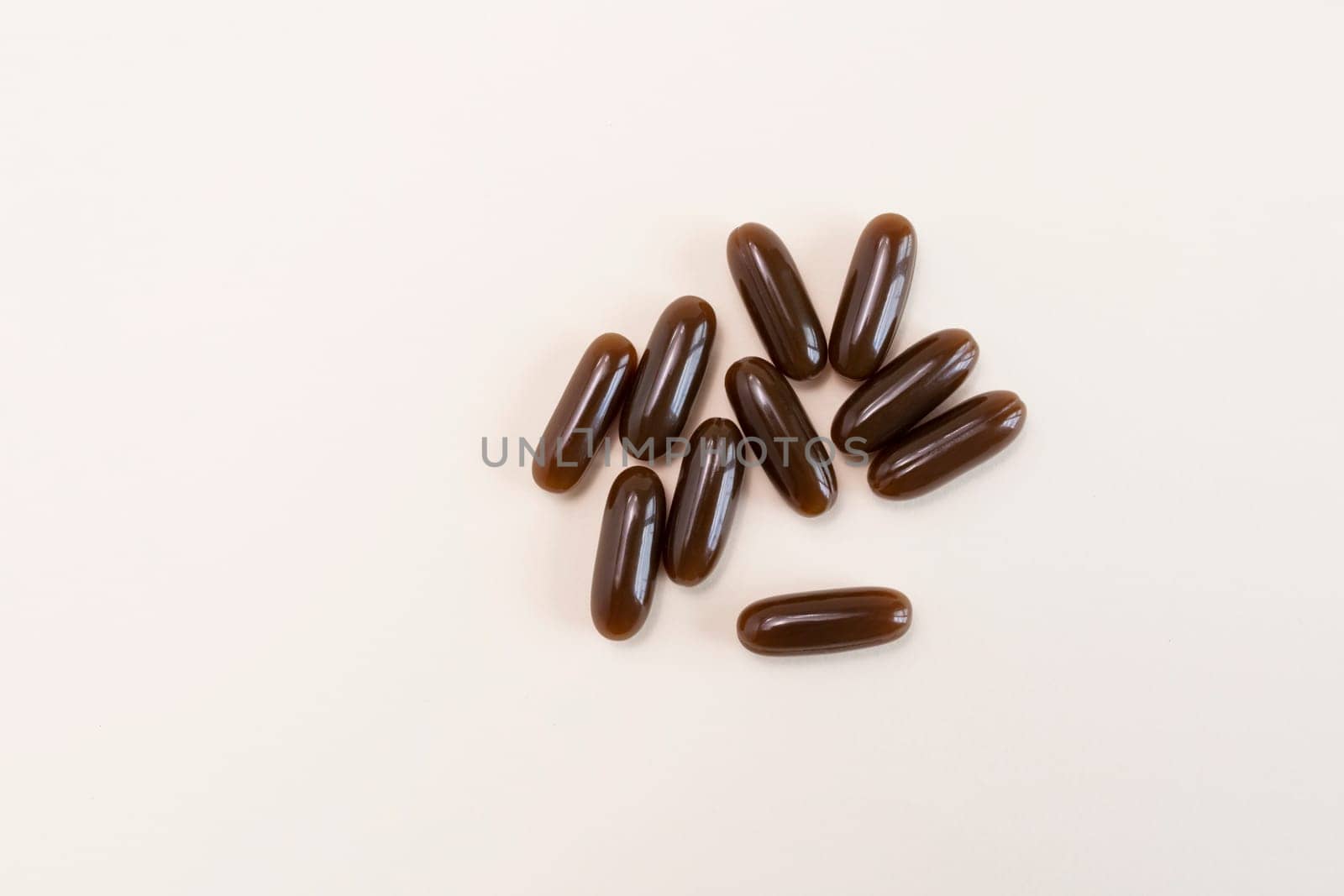 Isolated Flat lay Sunflower Lecithin Brown Softgel Pill, Capsule On White Beige Background. Top View Vitamin, Dietary Supplements. Lecithin Benefits, Copy Space, Design. Horizontal Plane.