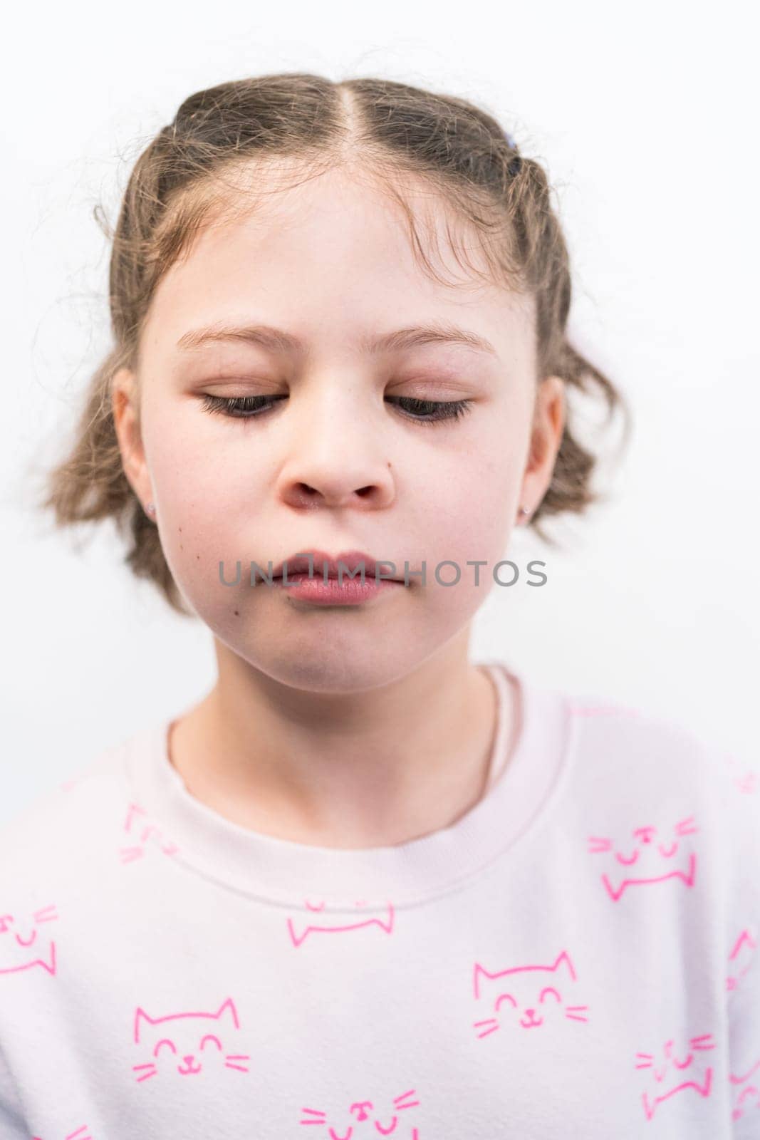 Little girl with rainbow braces smiling at the camera.