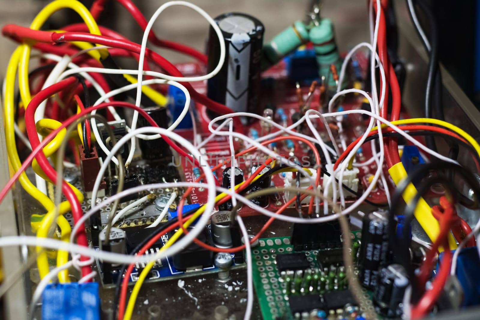 Boards and many colored wires in an electronic device close up