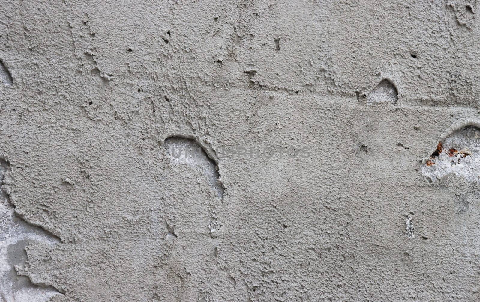 Rough dark gray relief plastered wall. by gelog67