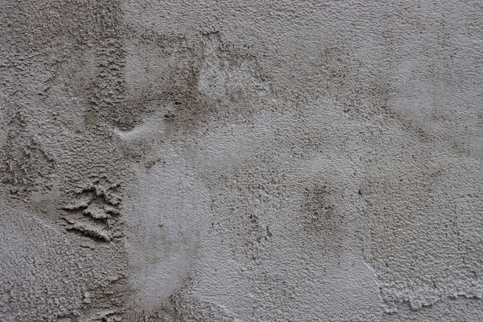 Rough dark gray relief plastered wall. by gelog67