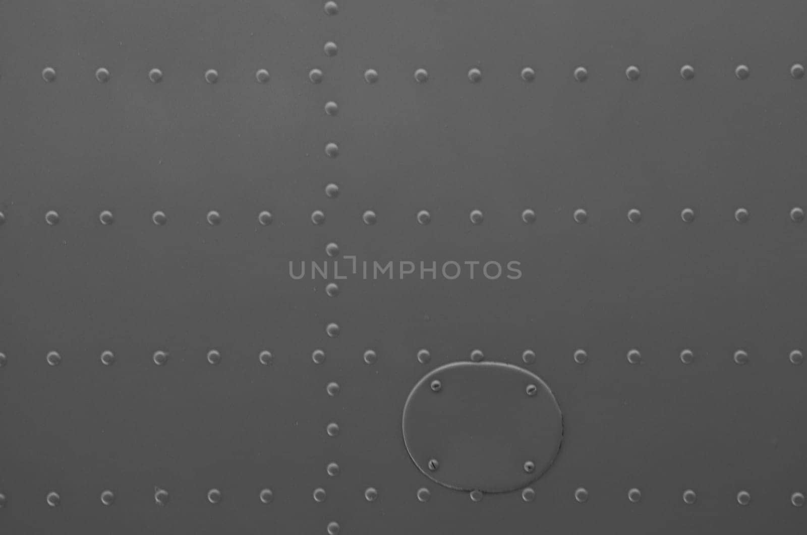 Iron panel of airplane. Texture and background of old metal surface of aircraft fuselage with rivets