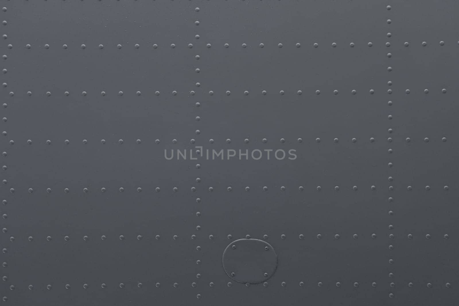 Iron panel of airplane. Texture and background of old metal surface of aircraft fuselage with rivets