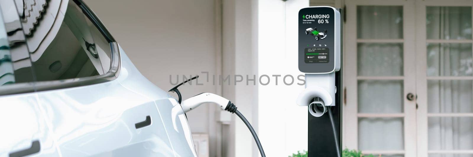 Electric vehicle technology utilized to residential home charging station for EV car battery recharge. Eco-friendly transport by clean and sustainable energy for future environment.Panorama Synchronos