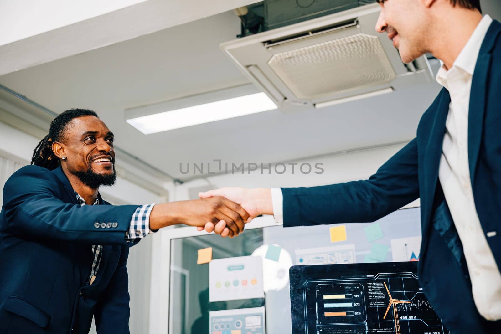 Close-up of a handshake between a young manager and a new employee, symbolizing success and collaboration in their business partnership. Men shake hands during a leadership meeting. by Sorapop