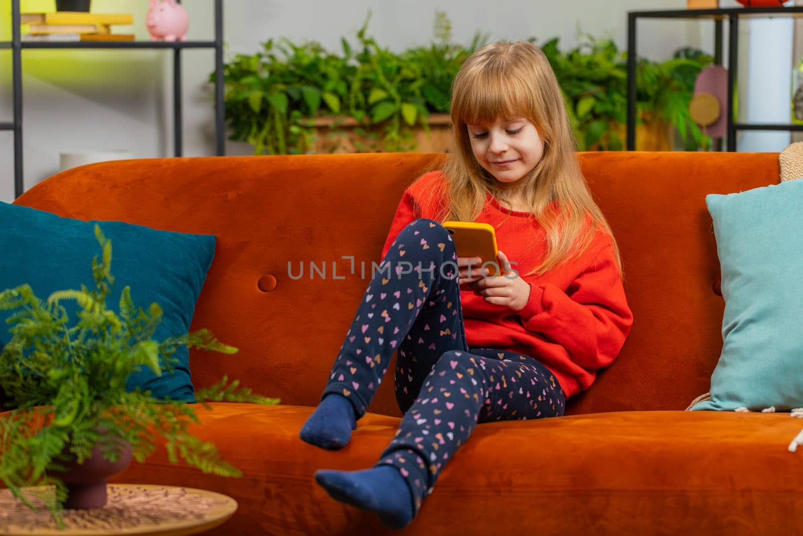 Young child kid girl texting share messages content on smartphone social media applications online by efuror