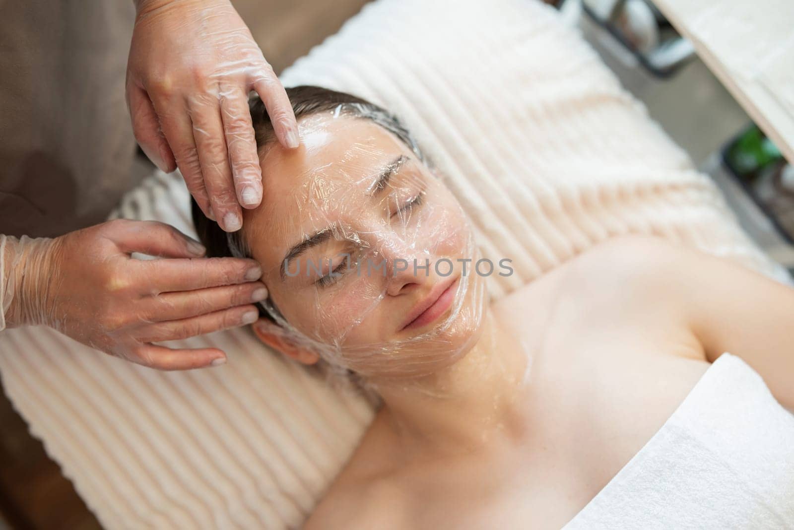 Cleaning of the face of a client in beauty salon