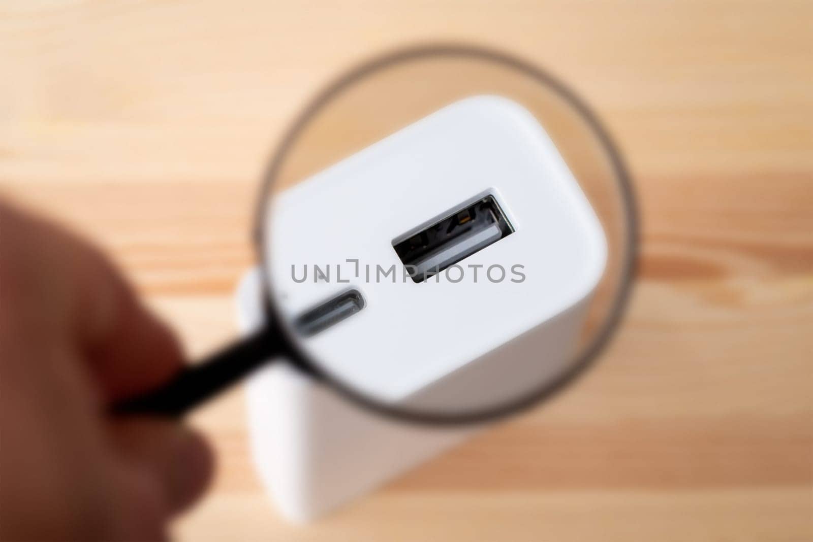 Magnifying glass on USB A port of power bank by VitaliiPetrushenko