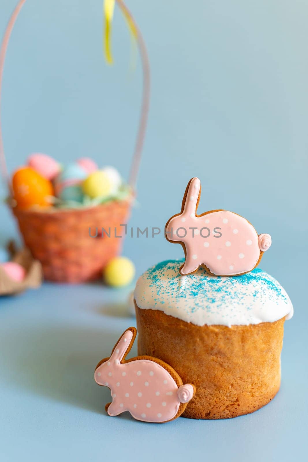 Still life with two pink gingerbread in the form of a rabbit on Easter cake by Zakharova