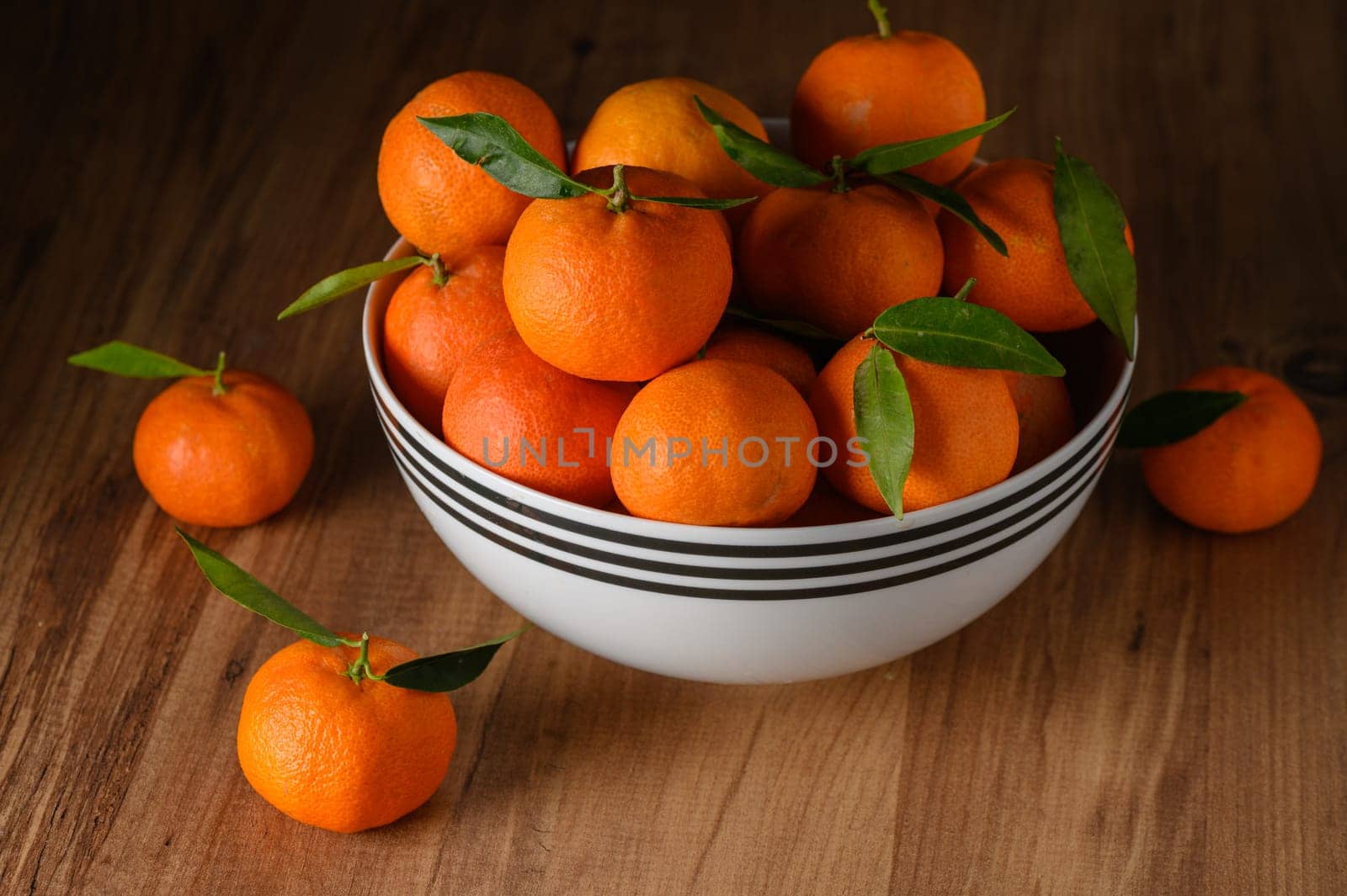 fresh juicy tangerines in a white bowl on a wooden table 4