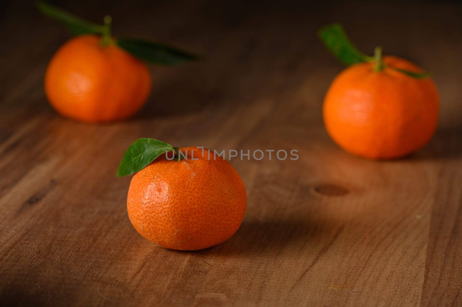 fresh juicy three tangerines on a wooden table 4 by Mixa74
