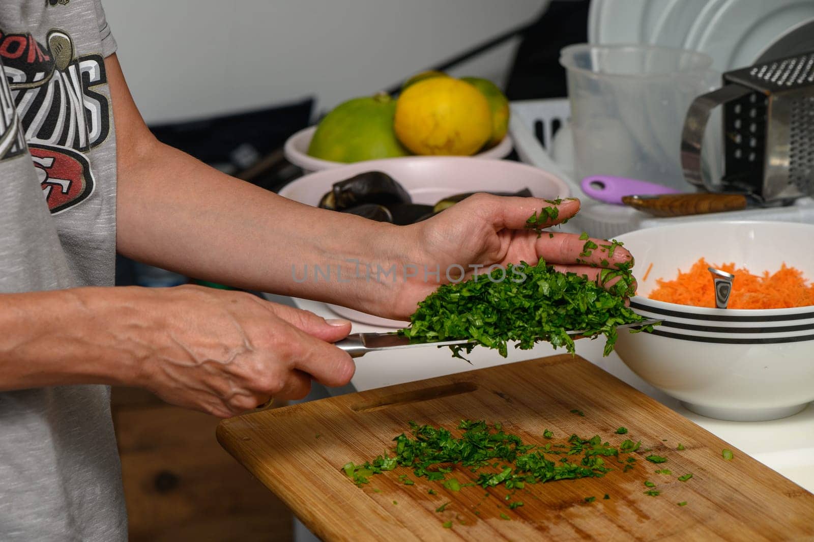 woman cutting parsley on a cutting board in the kitchen 7 by Mixa74