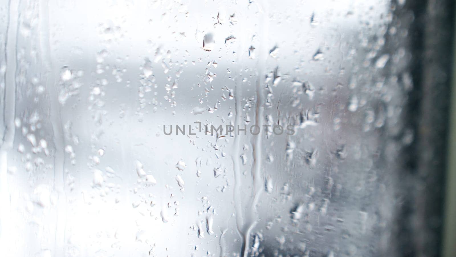Macro of water drops on glass. Large rain drops strike window during winter shower. Pure rain drops. by JuliaDorian
