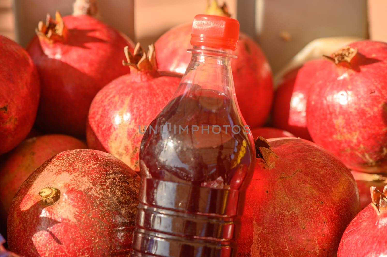 beautiful fresh pomegranates and pomegranate juice in a pile at a local market in the Mediterranean 1 by Mixa74