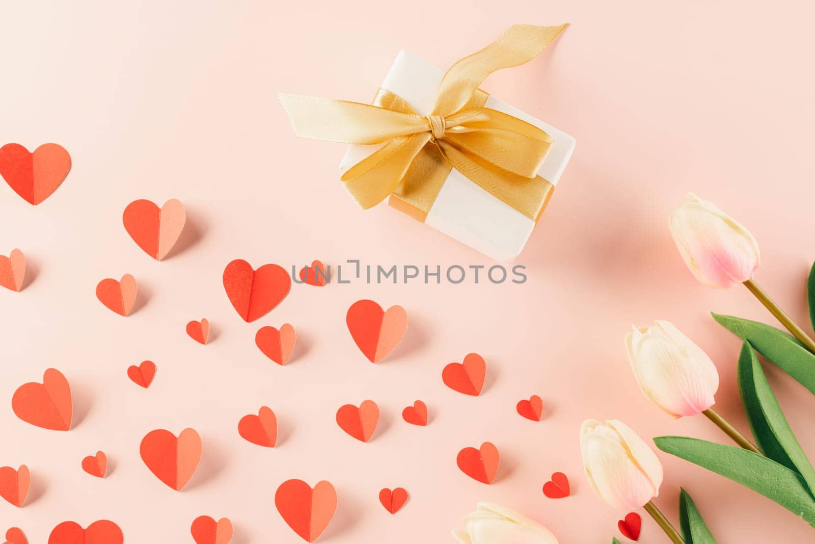 Happy Valentine Day Background. Top view flat lay of paper hearts, flower and gift box on pastel pink background surprise your loved with space for text, birthday greeting, web design banner holiday