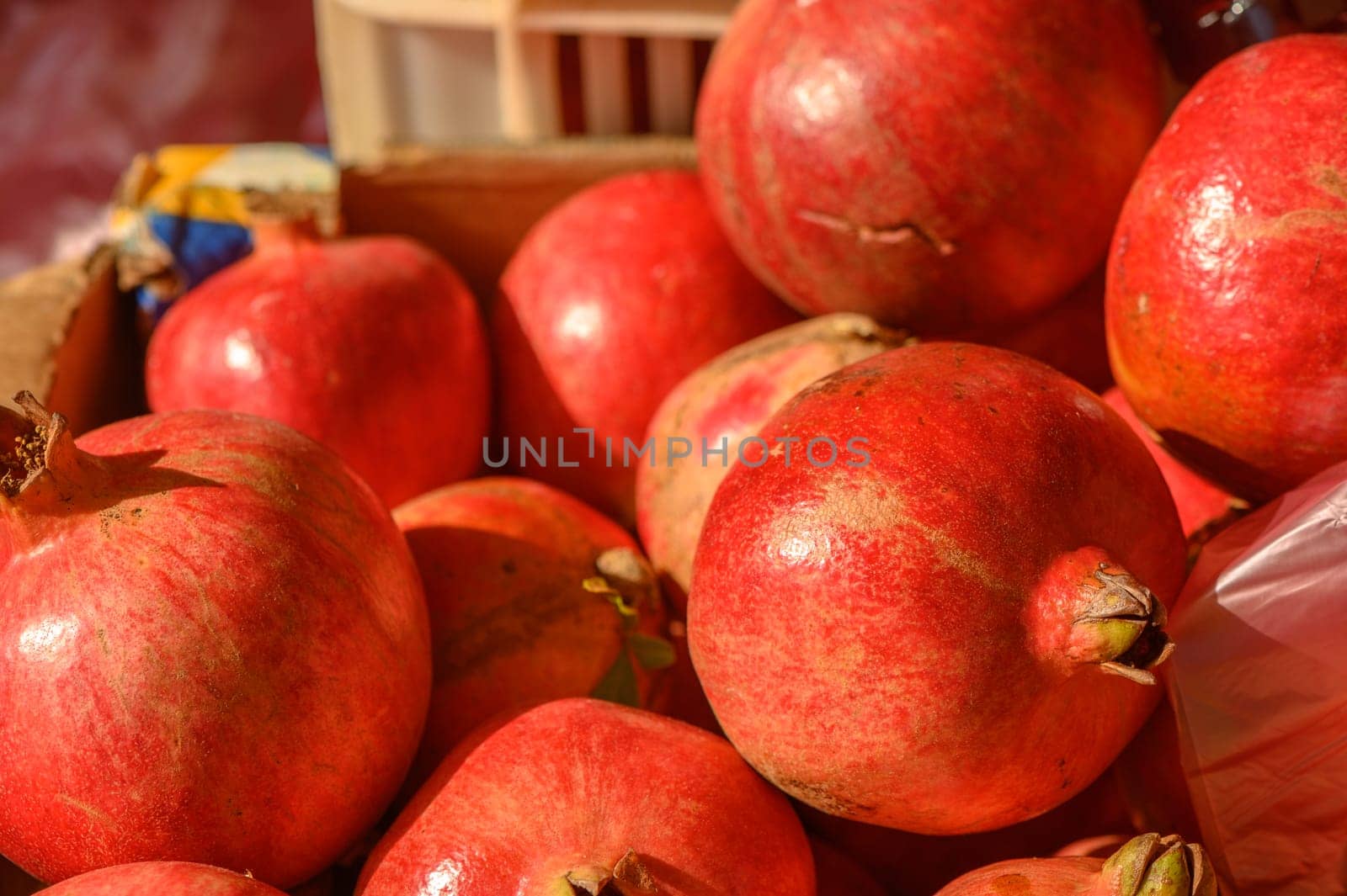 beautiful fresh pomegranates in a pile at a local market in the mediterranean