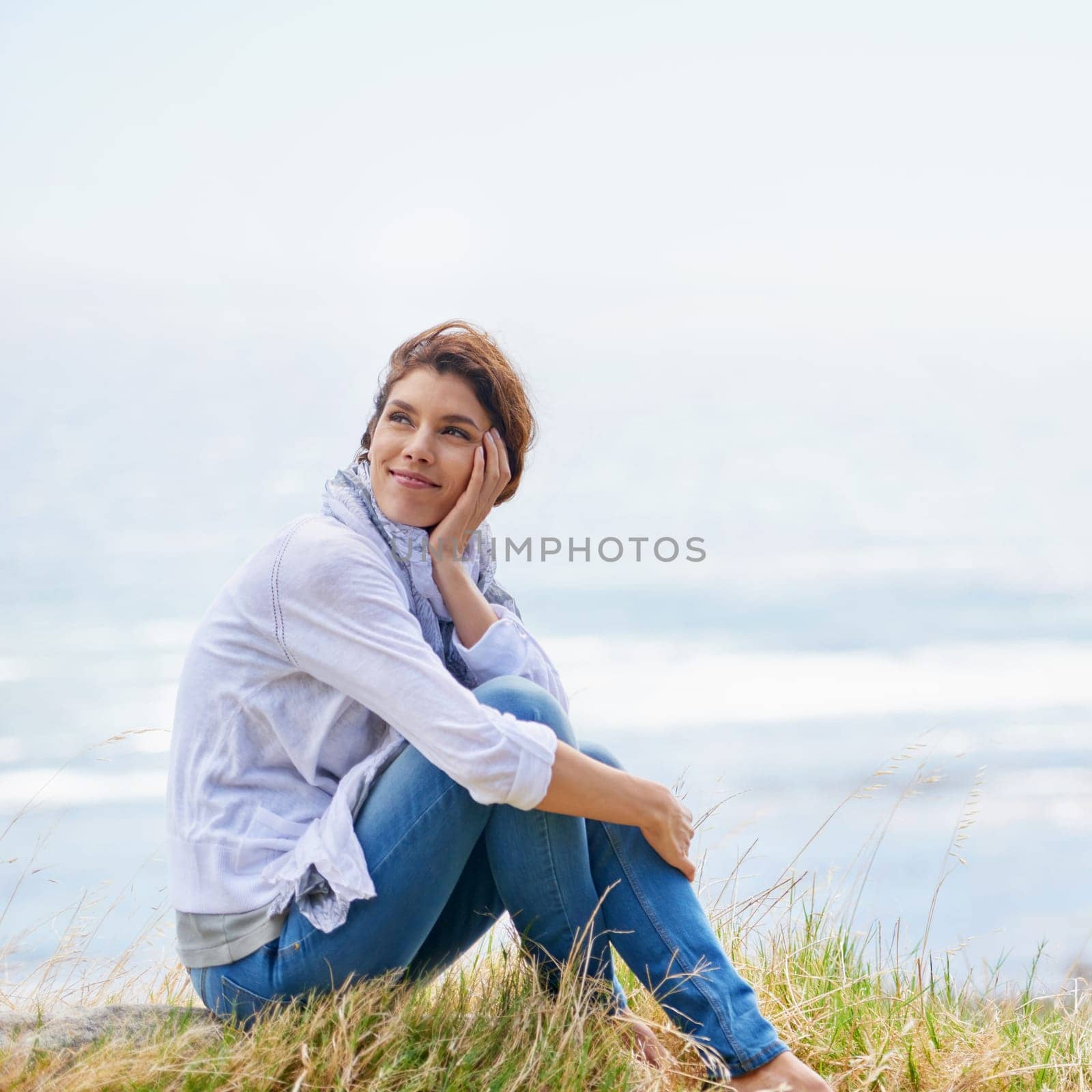 Woman, thinking and relax at beach in nature with happiness, gratitude and peace on holiday or vacation. Mindfulness, mock up and person on hill at the ocean or sea with ideas for future or travel.