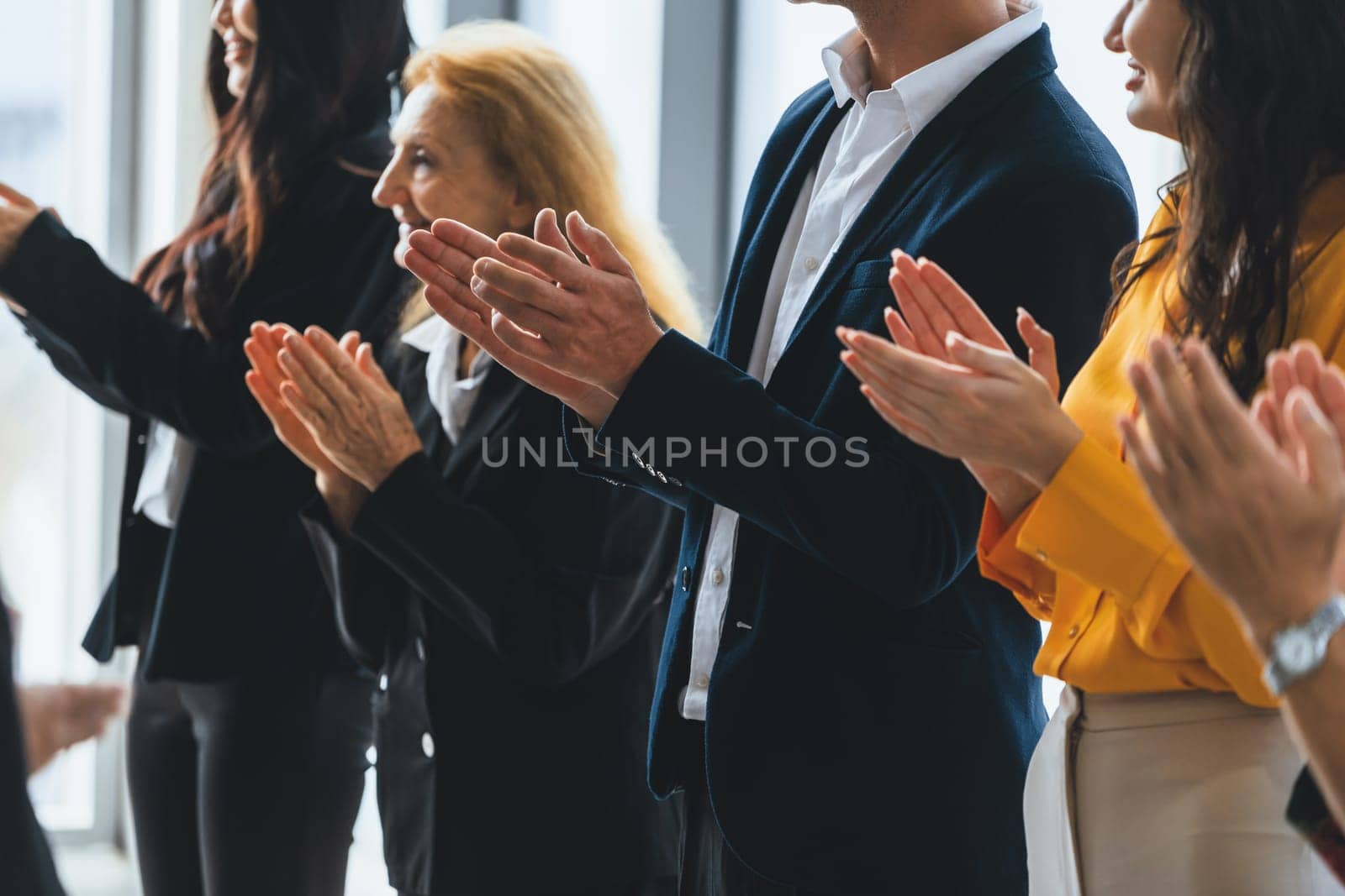 Group of business people clapping hands at successful presentation or conference. Cropped image focus on hand. Diverse male and female clapping hand to congratulate speaker. Side view. Intellectual.