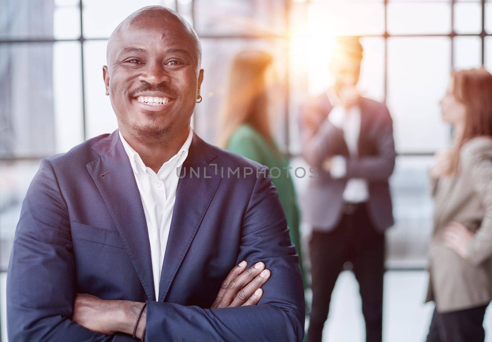 Handsome african american executive businessman in modern office by Prosto