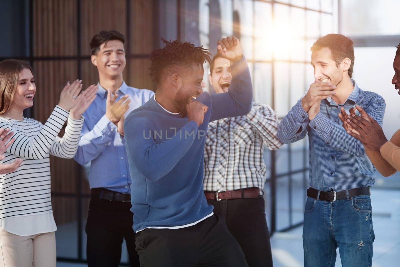Overjoyed diverse businesspeople triumph have fun dancing in modern office corridor, by Prosto