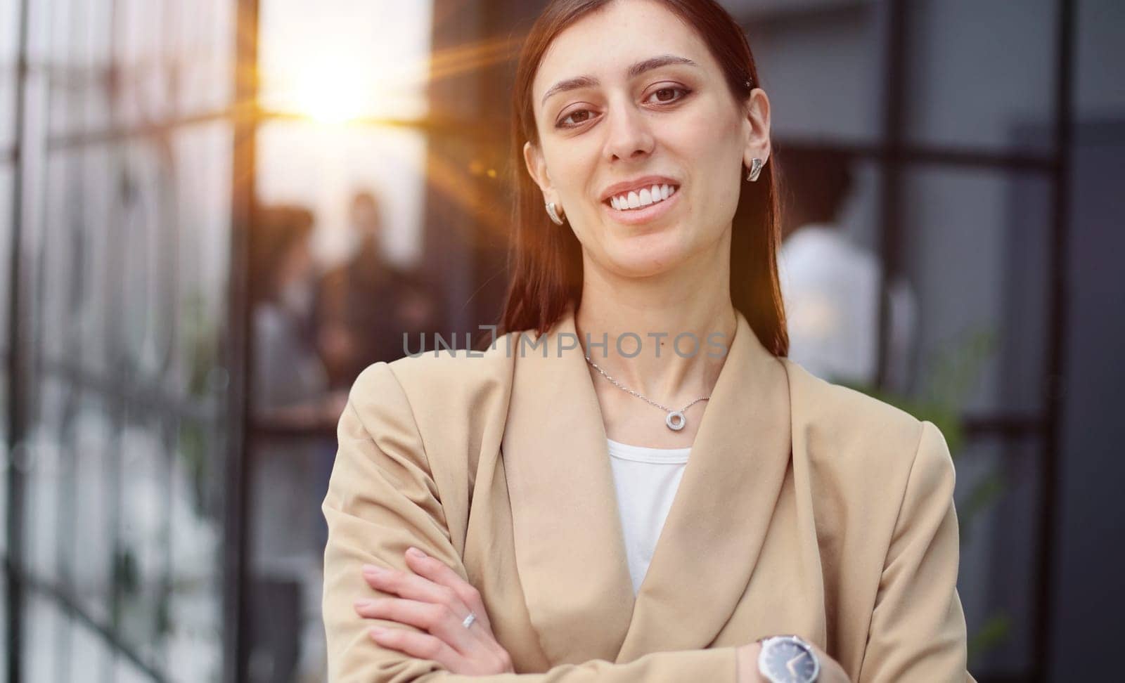 Happy young woman looking at the camera while greeting a client.