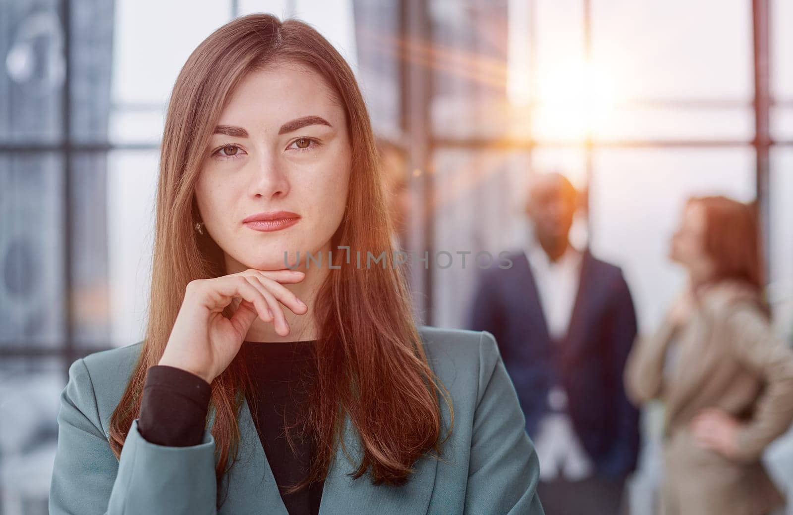 Portrait of a confident young businesswoman standing with her arms crossed in an office by Prosto