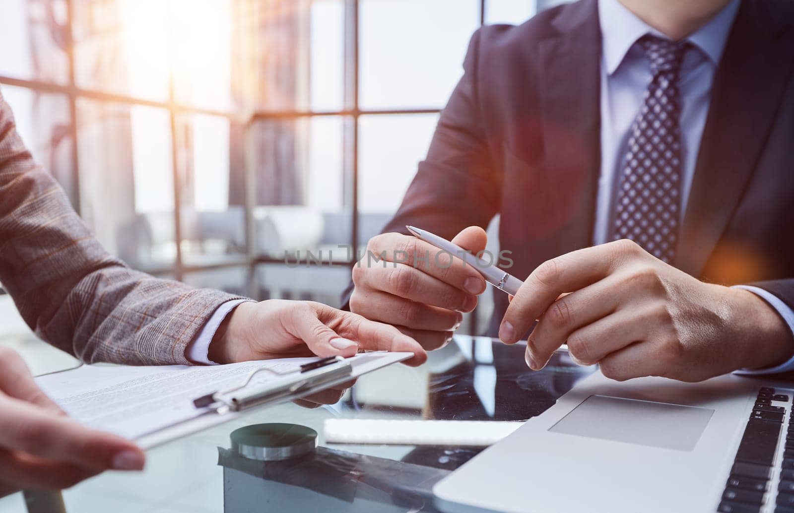 Close up businessman listening businessman about successful finance report.