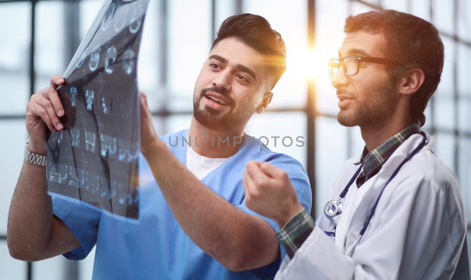 Two male doctors looking at brain x-ray by Prosto
