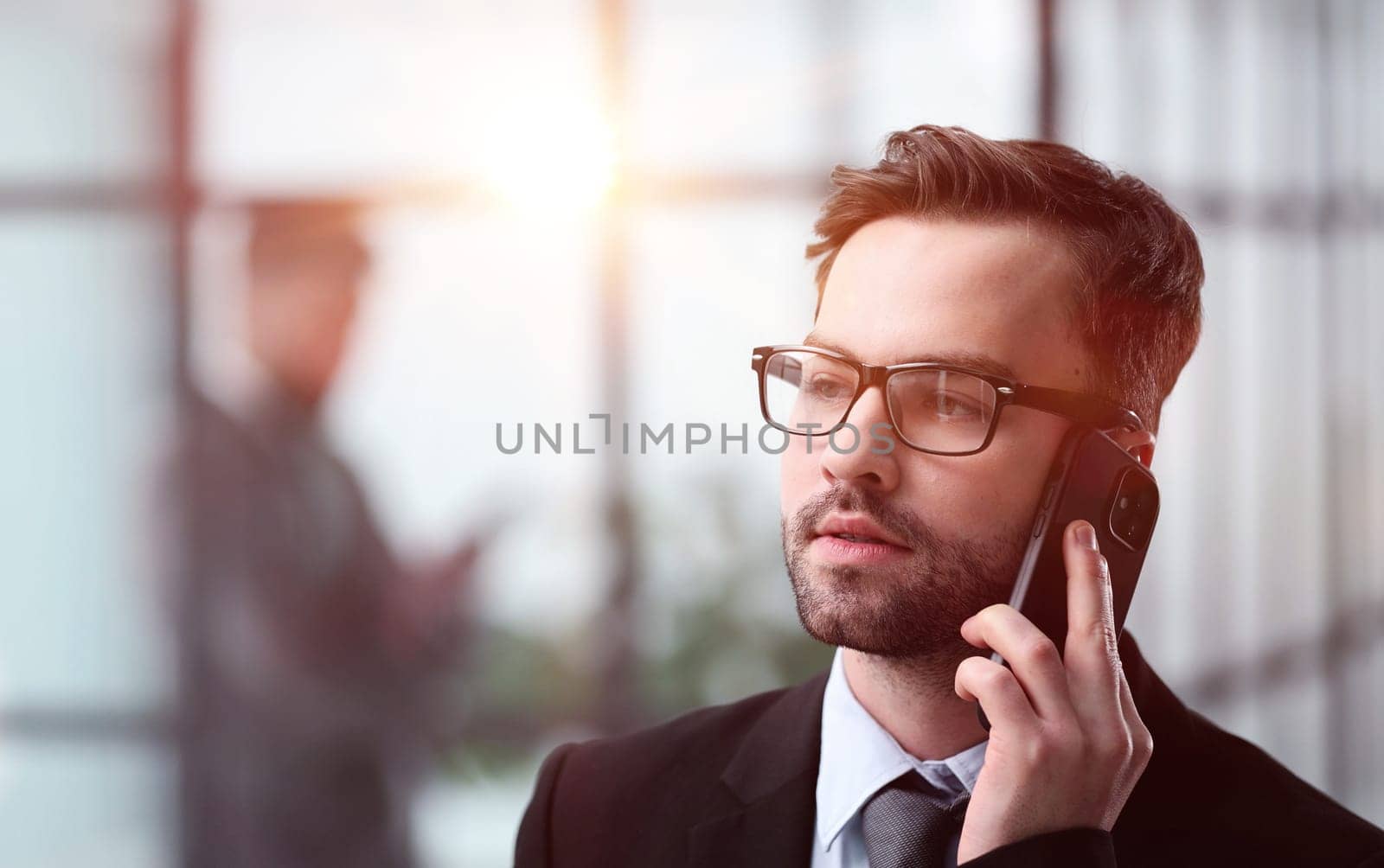 Close-up of a man in an office building talking on the phone,