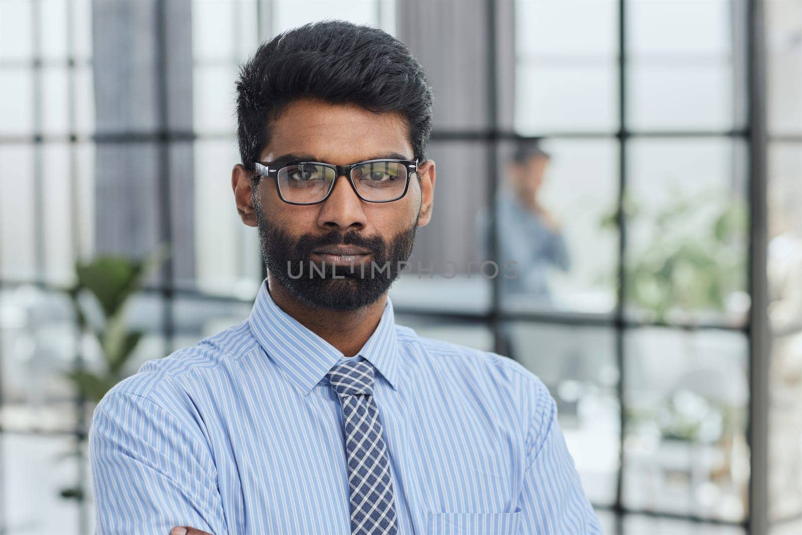 male investor beard looking at camera and smiling in modern office