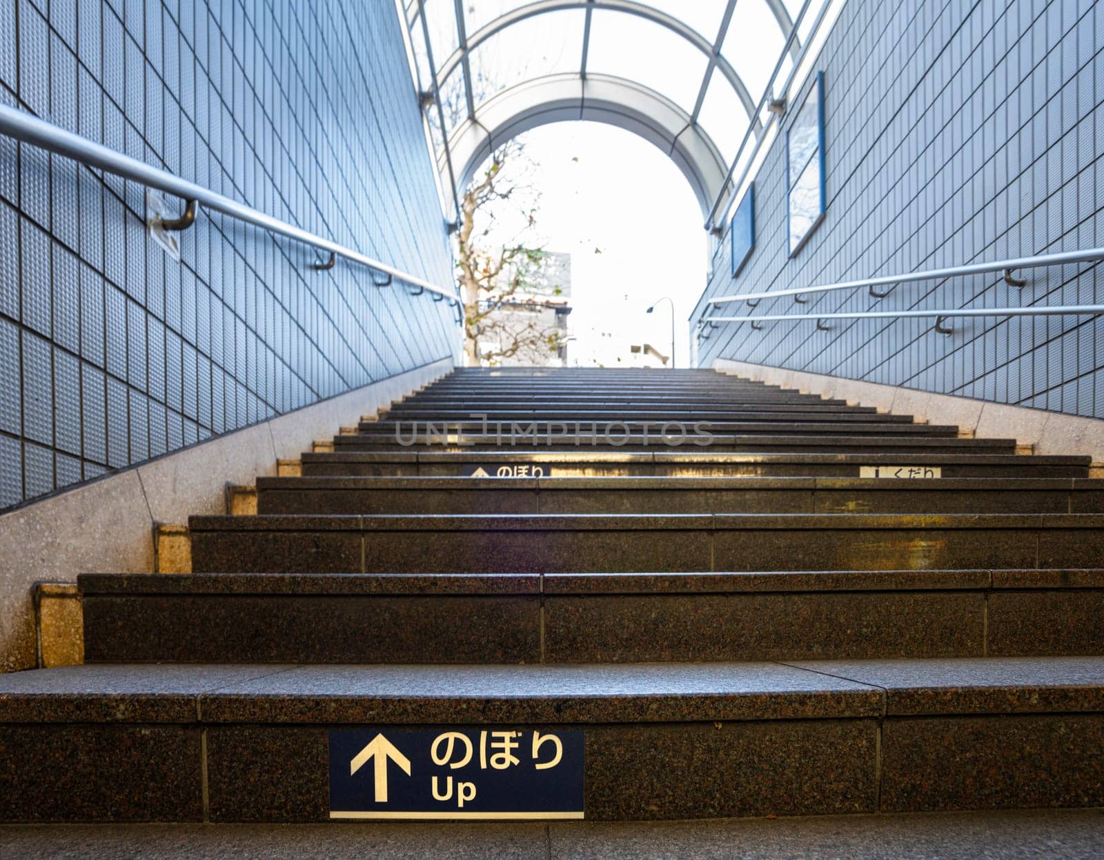 Tokyo, Japan, January 2024.  the steps of the staircase at the entrance of a subway station in the city center