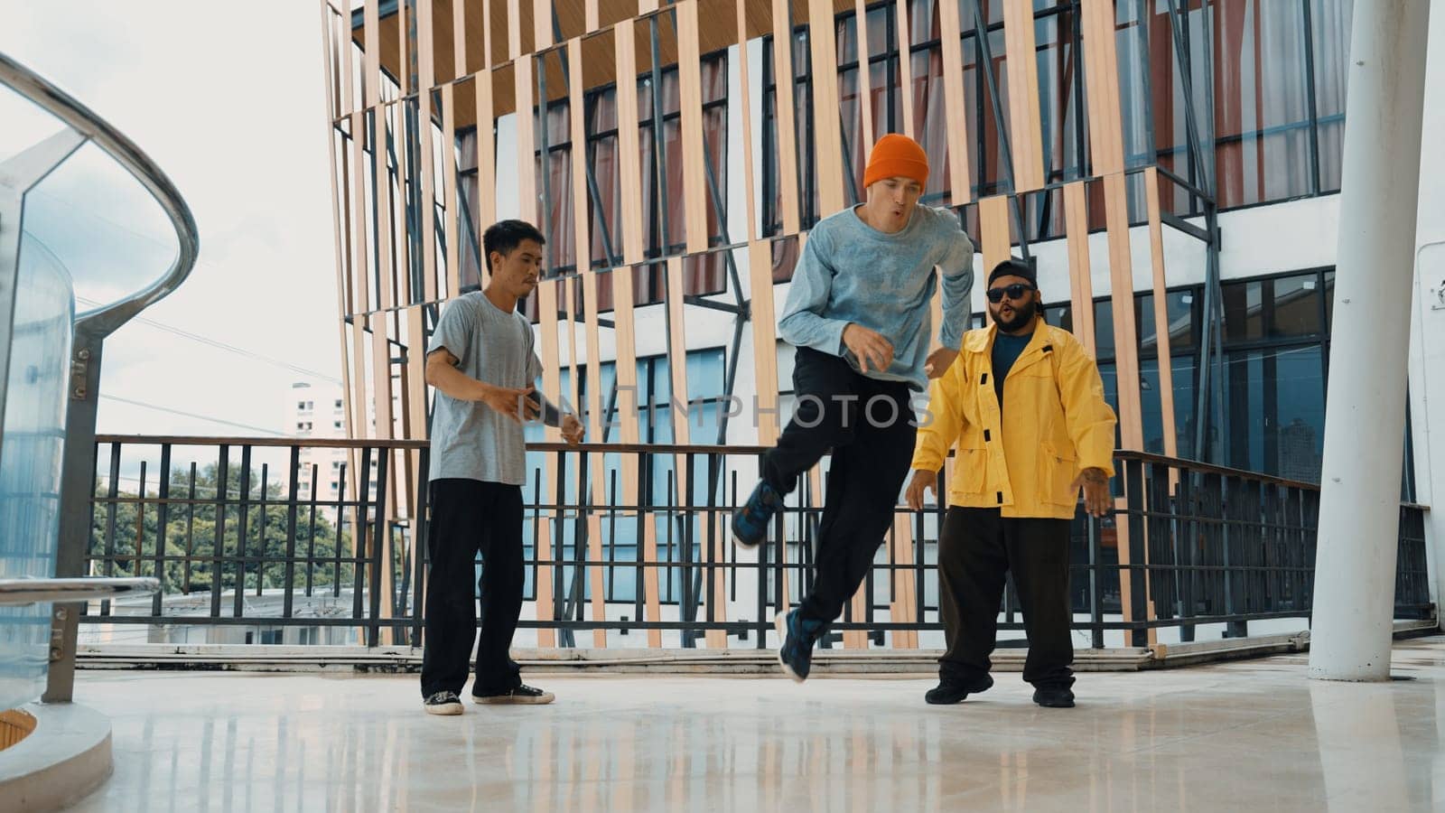 Hip hop team dance break dance while multicultural friend surrounded and clapping hands to cheer or encourage his friend to dance. Active and energetic street dance. Outdoor sport 2024. Endeavor.