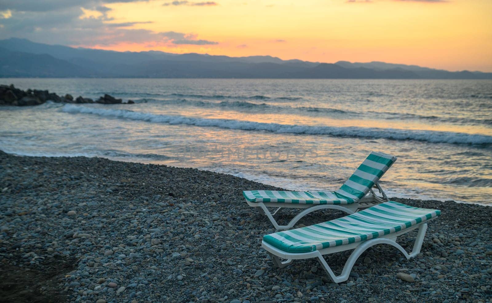 sun loungers on the beach at sunset on the Mediterranean Sea in Northern Cyprus 1 by Mixa74