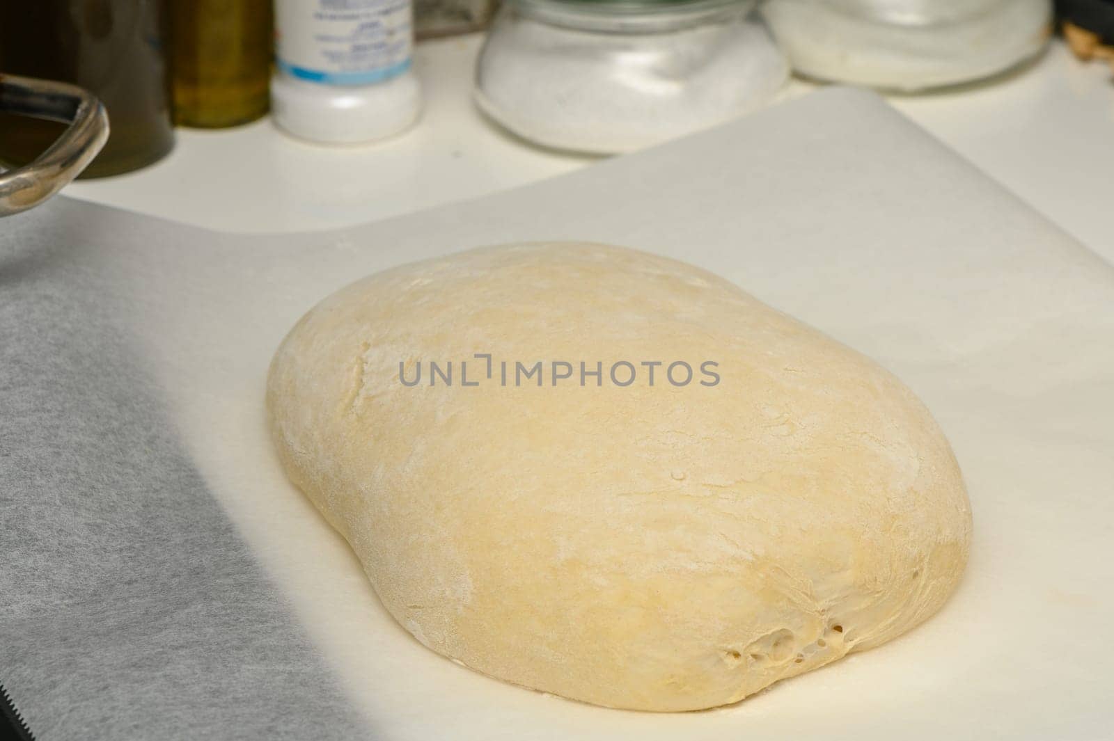 dough for homemade bread lies on the kitchen table before going into the oven 10