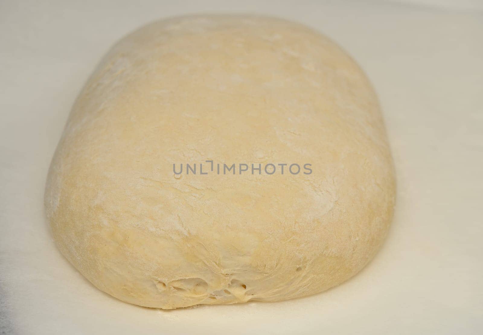 dough for homemade bread lies on the kitchen table before going into the oven 7 by Mixa74