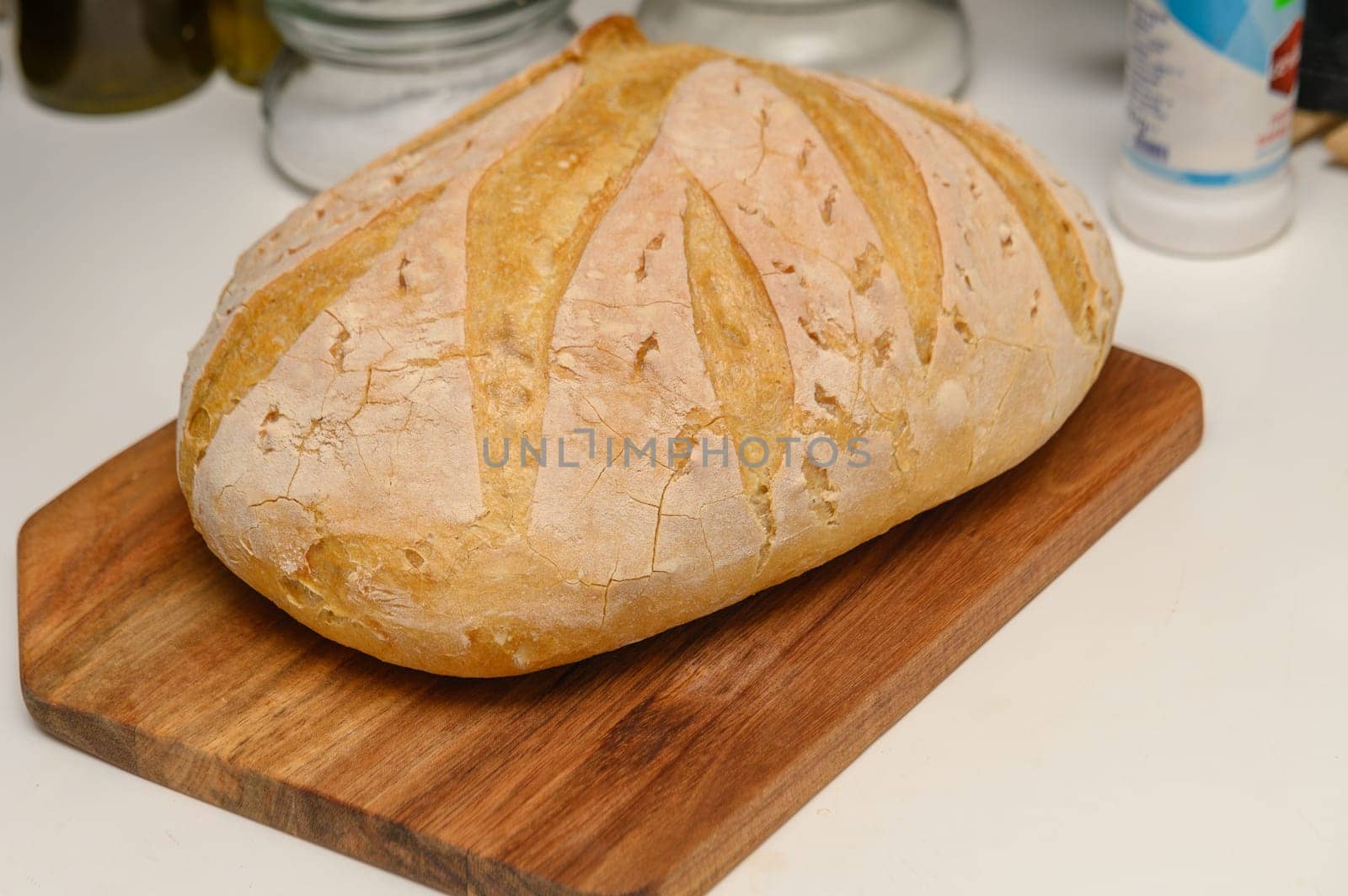 freshly baked homemade bread on the kitchen table on a light background 12