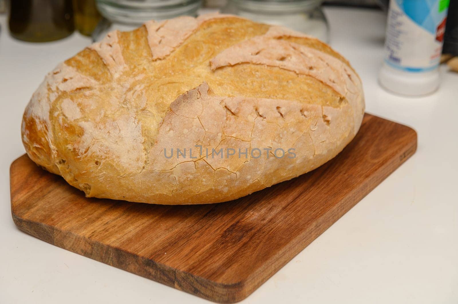 freshly baked homemade bread on the kitchen table on a light background 11