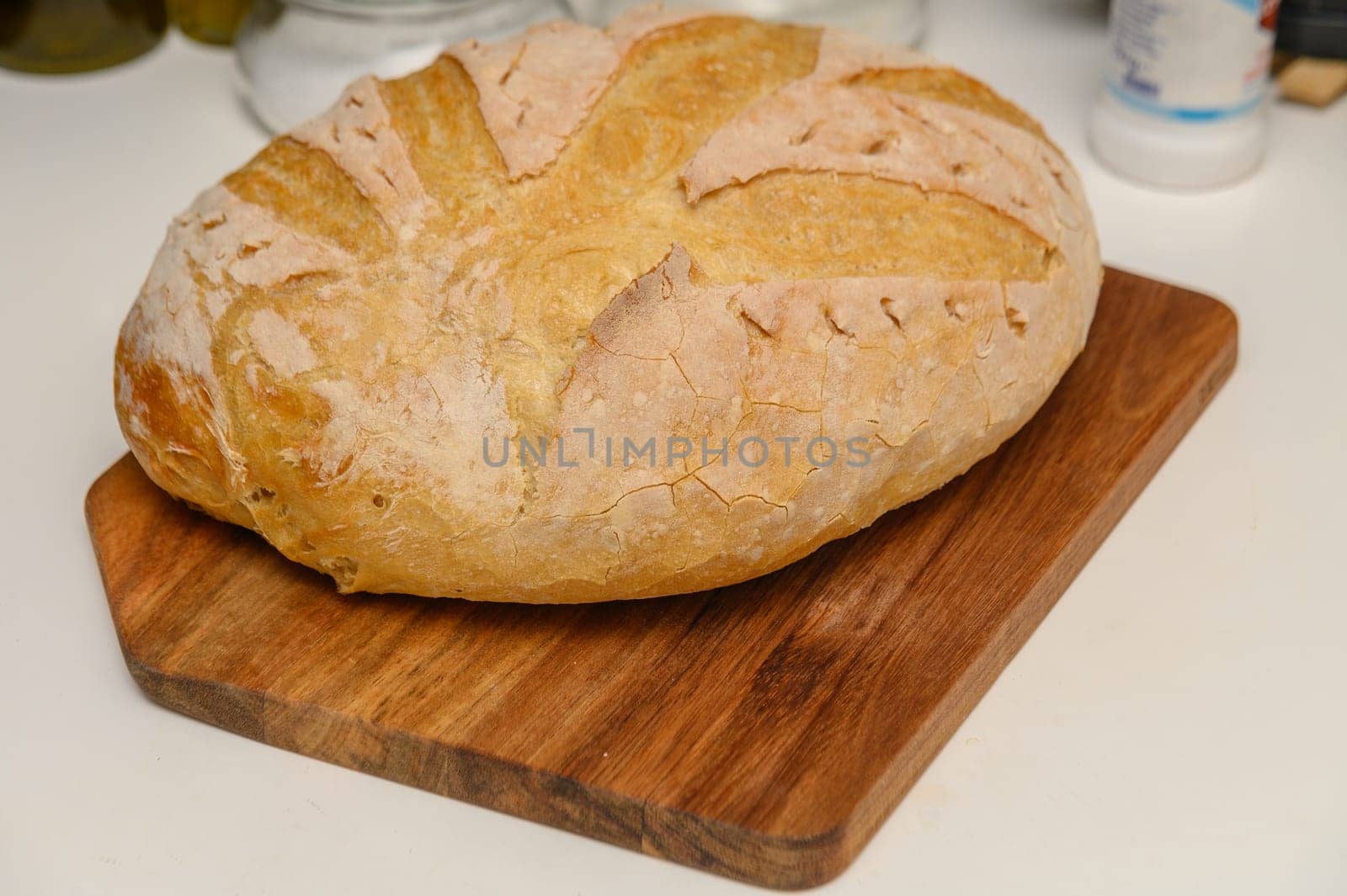 freshly baked homemade bread on the kitchen table on a light background 9