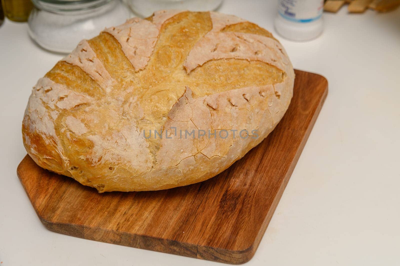 freshly baked homemade bread on the kitchen table on a light background 8