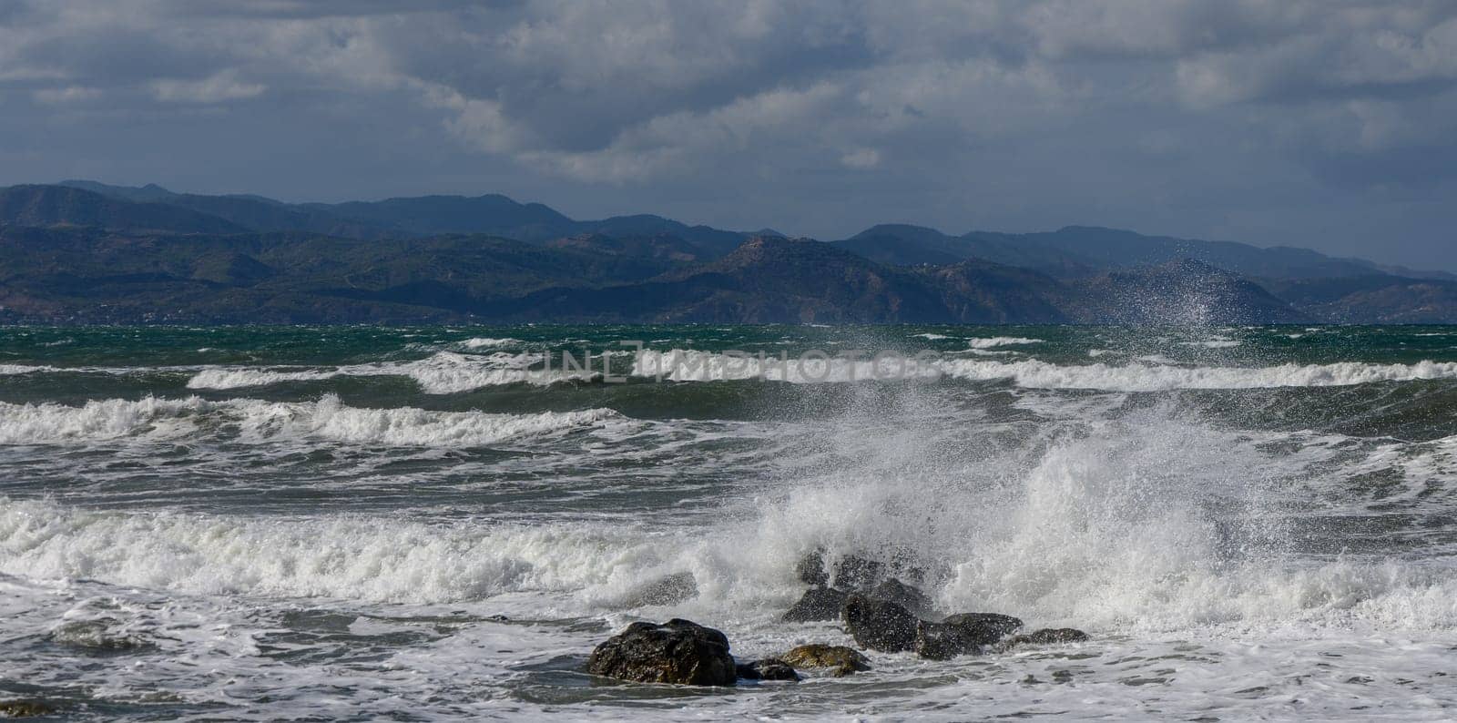 waves break on a stone in the Mediterranean Sea in autumn on the island of Cyprus 1