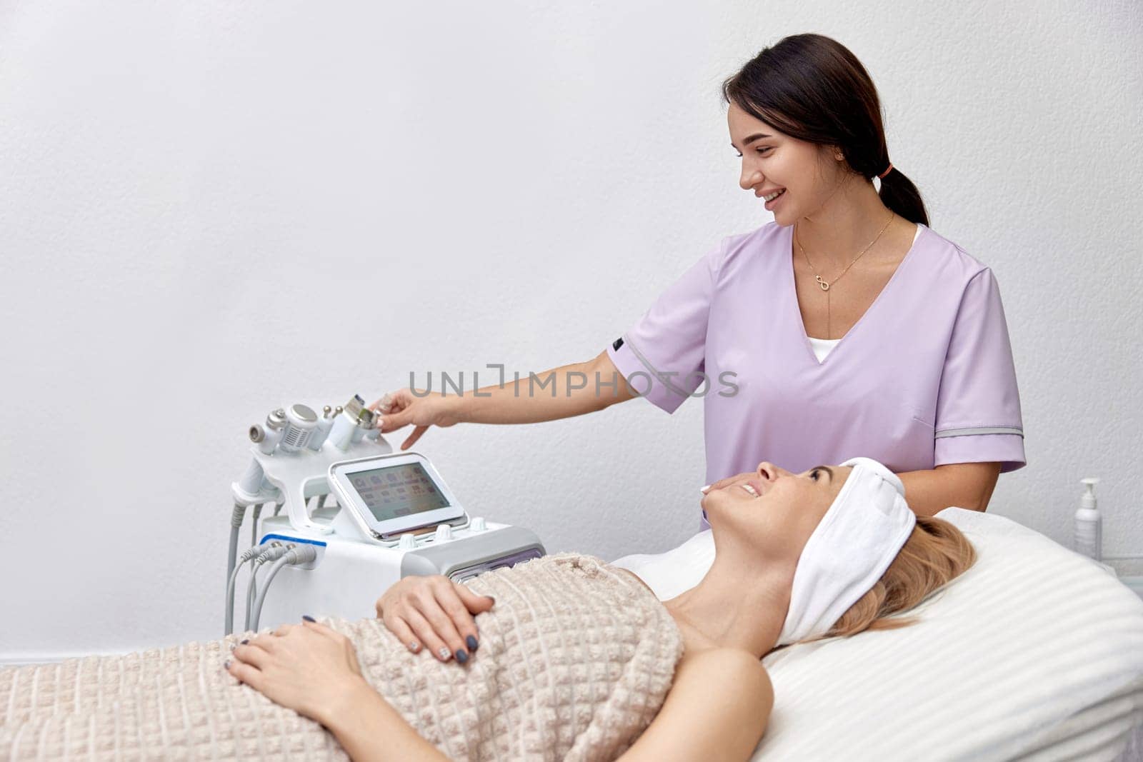 beautiful woman lying on bed in beauty clinic.